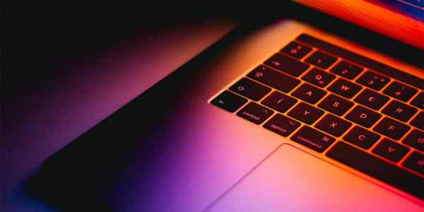 Close up of a Mac Book keyboard and trackpad.