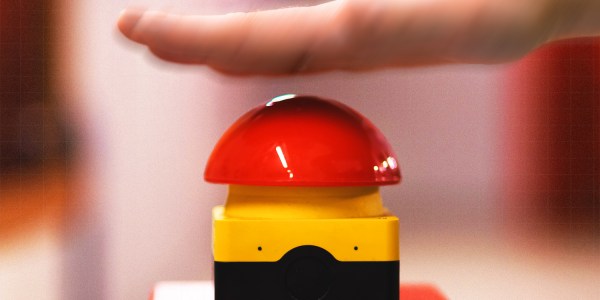 A hand smashing a big red button to indicate the RBA raising interest rates.