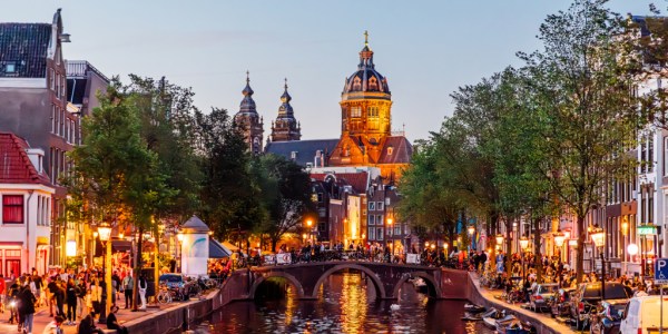 View of a river in Amsterdam showing overtourism of the area.